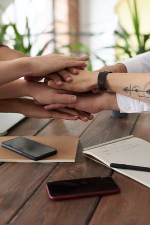 group of people holding hands together