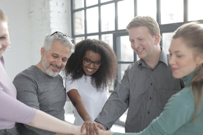 colleagues joining hands together