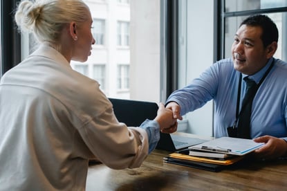 employer shaking employee's hand during meeting