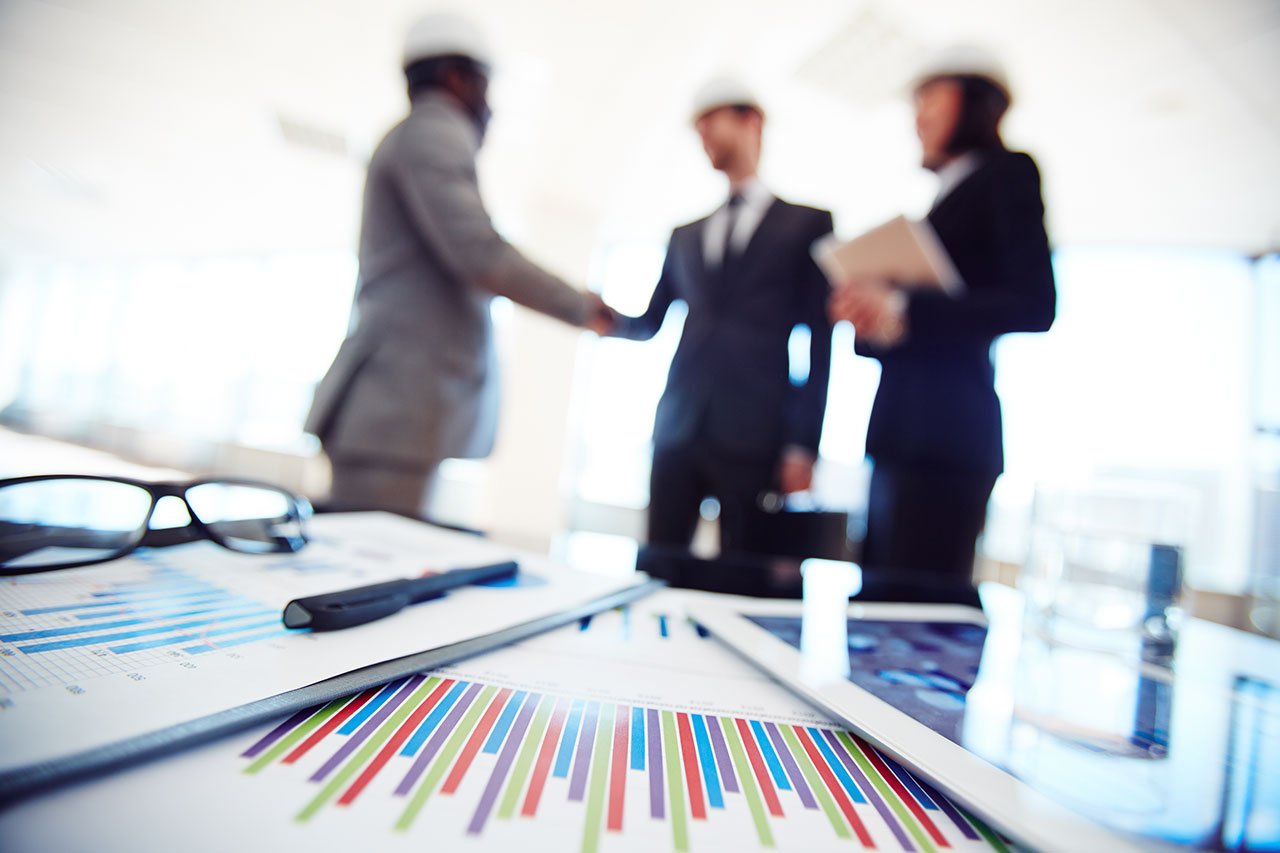 close-up-documents-with-executives-background close-up-documents-with-executives-background