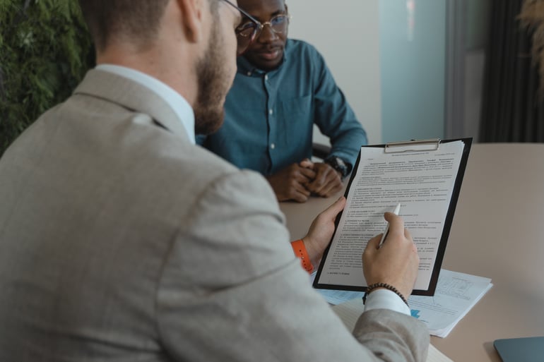 Man Reading performance feedback notes to employee